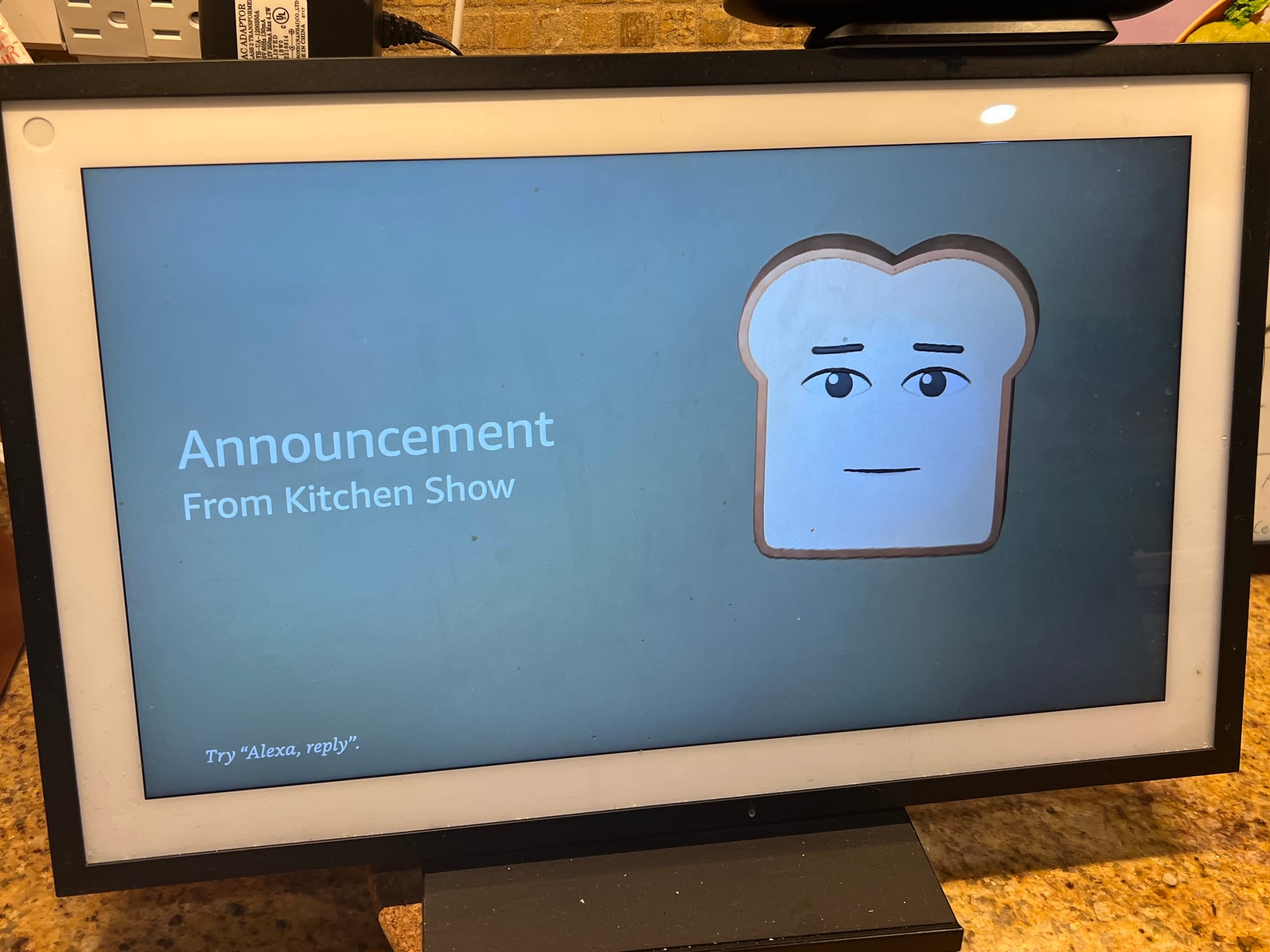 Photo of Alexa Device with an animated piece of toast announcing 'time for dinner'